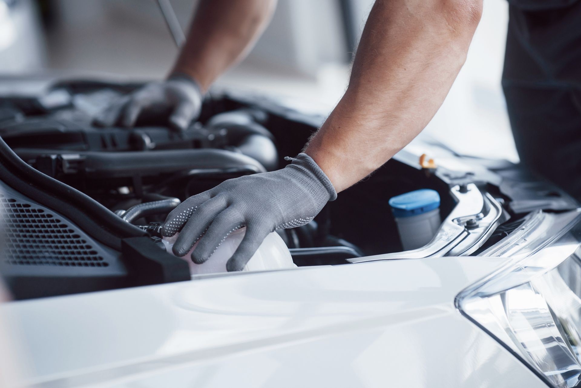 Auto mechanic working in garage. Repair service.